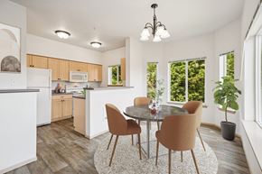 Olympia apartment for rent - Virtually staged kitchen in the Jackson floor plan with a dining table at The Madison apartments in Olympia, WA