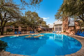 San Antonio apartment for rent - a large swimming pool with a building in the background