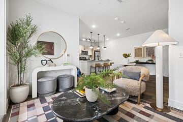 Waco apartment for rent - A living room with a black table and a grey sofa.