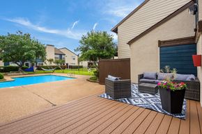 Dallas apartment for rent - a backyard with a swimming pool and patio furniture
