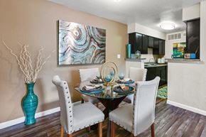 Houston apartment for rent - a dining room with a table and chairs and a kitchen in the background