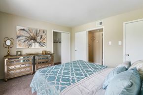 Houston apartment for rent - a bedroom with a large bed and a dresser