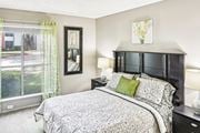 Austin apartment for rent - Model apartment bedroom with a bed and a large window at Hunters Chase in Austin, TX