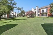 Austin apartment for rent - Lush green landscape with pet waste collection stations at Hunters Chase in Austin, TX