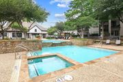 Irving apartment for rent - A sparkling pool surrounded by lush trees at Jefferson Place Apartments in Irving, TX