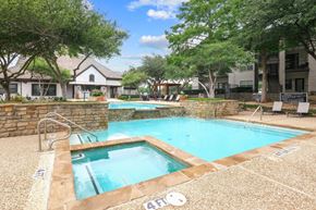 Irving apartment for rent - A sparkling pool surrounded by lush trees at Jefferson Place Apartments in Irving, TX