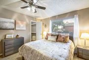 Austin apartment for rent - a bedroom with a bed and a ceiling fan