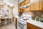 Austin apartment for rent - a kitchen with white appliances and a dining room table