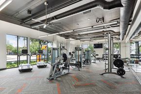 Houston apartment for rent - Our gym with a variety of equipment including treadmills, weight machines, and free weights at Muse at Museum District apartments in Houston, TX