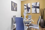 Houston apartment for rent - a dining room with a table and chairs and paintings on the wall
