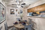 Austin apartment for rent - a dining area with a table and chairs and a ceiling fan