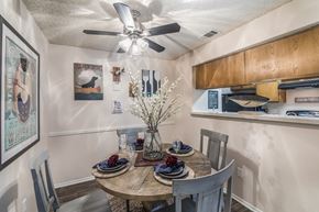 Austin apartment for rent - a dining area with a table and chairs and a ceiling fan