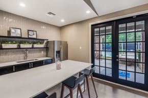 Austin apartment for rent - a kitchen with a long counter and a door to a patio