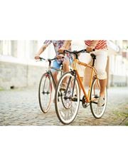 North Miami Beach apartment for rent - Two people riding bicycles on a cobblestone street.