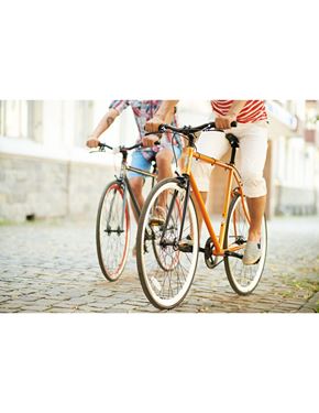 North Miami Beach apartment for rent - Two people riding bicycles on a cobblestone street.