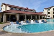 Austin apartment for rent - A pool with a fountain in the middle of it.