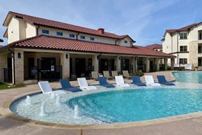 Austin apartment for rent - A pool with a fountain in the middle of it.