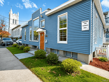 Norwalk apartment for rent - A blue house with a sign that says "PARKING FOR TENANTS ONLY" on the front.