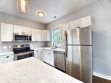 Norwalk apartment for rent - A kitchen with a refrigerator, oven, and microwave.