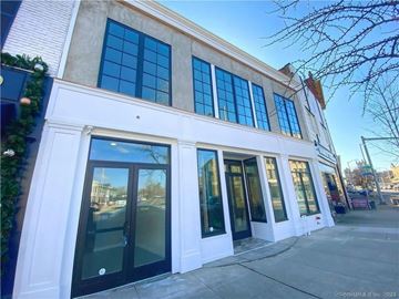 Norwalk apartment for rent - A white building with black doors and windows.