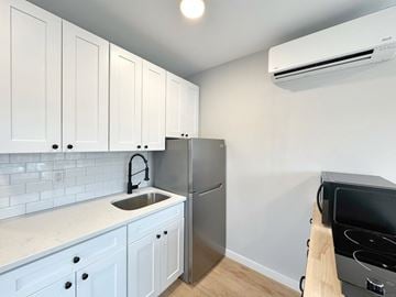 Norwalk apartment for rent - A kitchen with white cabinets and a stainless steel refrigerator.