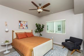 Fresno apartment for rent - a bedroom with a bed and a ceiling fan