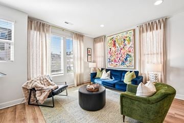 Charlotte townhouse for rent - A living room with a blue couch and a green armchair.