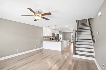 Lebanon townhouse for rent - A spacious living room with a staircase leading to the upper floor.