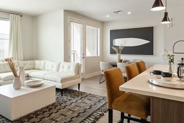 Tempe apartment for rent - a living room and dining room area with a white couch and a table and chairs