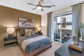 Glendale apartment for rent - A bedroom with a bed, nightstands, and a ceiling fan.
