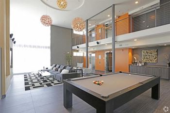 Community lounge with 75” tv for viewing and pool table