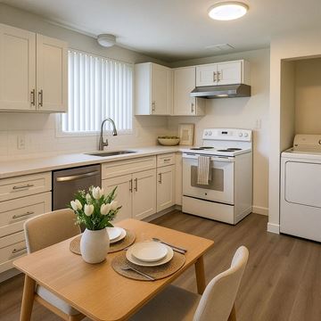 Monroe apartment for rent - A kitchen with a table set for two with a vase of white flowers.