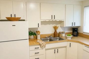 Lakewood apartment for rent - A kitchen with white cabinets and a wooden countertop.