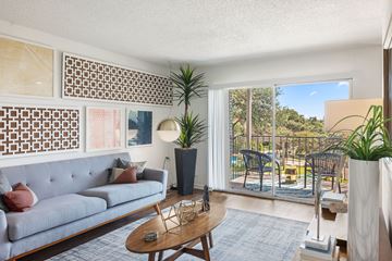 Austin apartment for rent - A living room with a grey couch and a wooden coffee table.