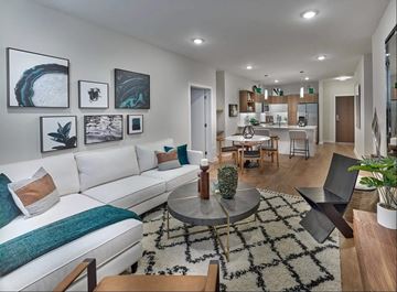 Downingtown apartment for rent - A modern living room with a white sofa and a coffee table.