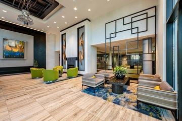 Alexandria apartment for rent - A modern living room with a wooden floor and a large abstract painting on the wall.
