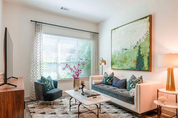 Exton apartment for rent - A living room with a couch, chair, and a painting on the wall.