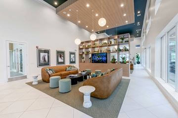West Palm Beach apartment for rent - A modern living room with a long sofa and a coffee table.