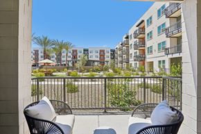 Mesa apartment for rent - Two chairs are on a balcony with a view of apartment buildings.