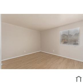 Phoenix apartment for rent - an empty room with a window and wood floors