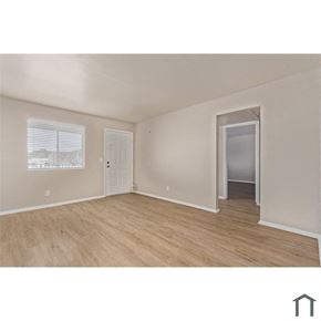 Phoenix apartment for rent - an empty living room with a door to a hallway