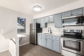 Phoenix apartment for rent - a kitchen with stainless steel appliances and white cabinets