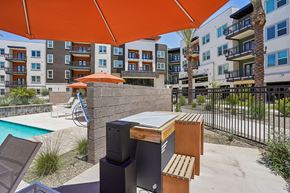 Mesa apartment for rent - A patio with a pool and a table with chairs.