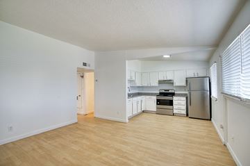 Phoenix apartment for rent - A kitchen with white cabinets and a stainless steel refrigerator.
