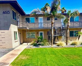 Scottsdale apartment for rent - A building with the number 4613 on it has a balcony and a tree in front.
