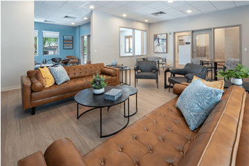 Phoenix apartment for rent - A living room with brown leather couches and a coffee table.