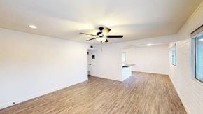 Scottsdale apartment for rent - A room with a ceiling fan and wooden flooring.