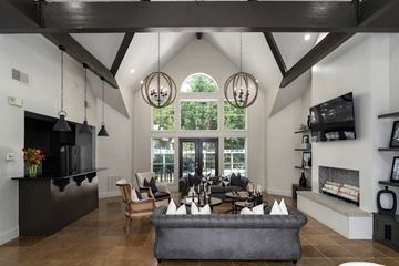 Birmingham apartment for rent - A modern living room with a grey sofa and a black kitchen area.