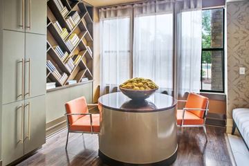 Birmingham apartment for rent - A modern kitchen with a round table and orange chairs.