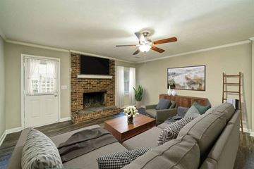 Conyers apartment for rent - A living room with a grey couch and a fireplace.